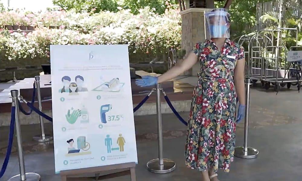 The Bellevue Resort Panglao Esterno foto A woman wearing a face shield at the entrance of a hotel in Paris, France